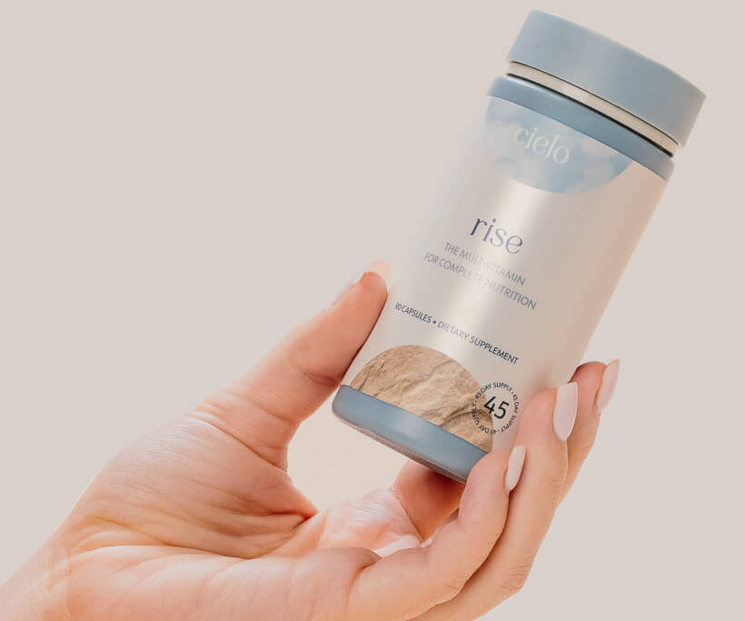 a hand holding cielo's rise multivitamin