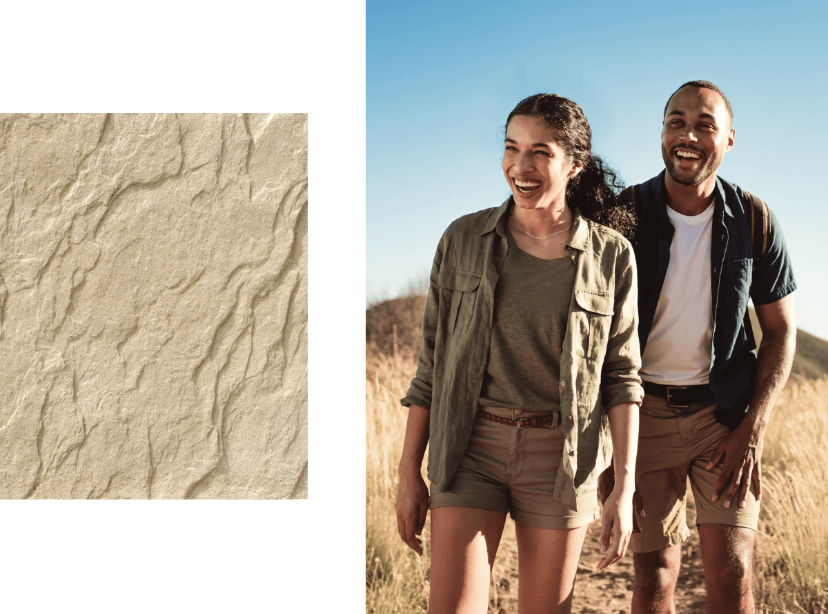 a multicultural couple smiling and hiking